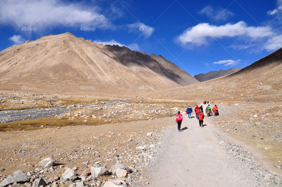 People walking towards mountain