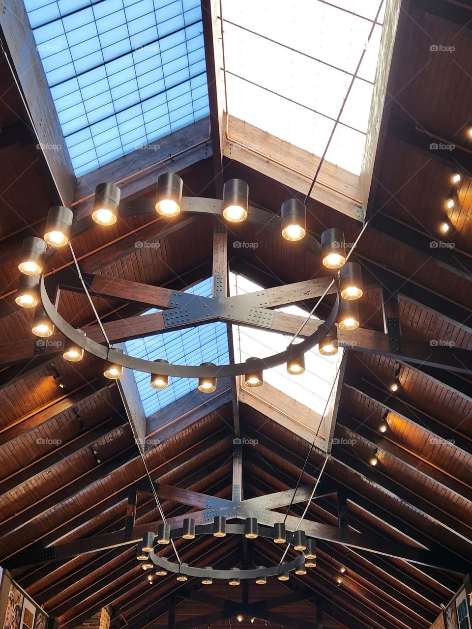 multiple lights and windows surrounded by dark wooden beams create an impressive visual experience in an Oregon store