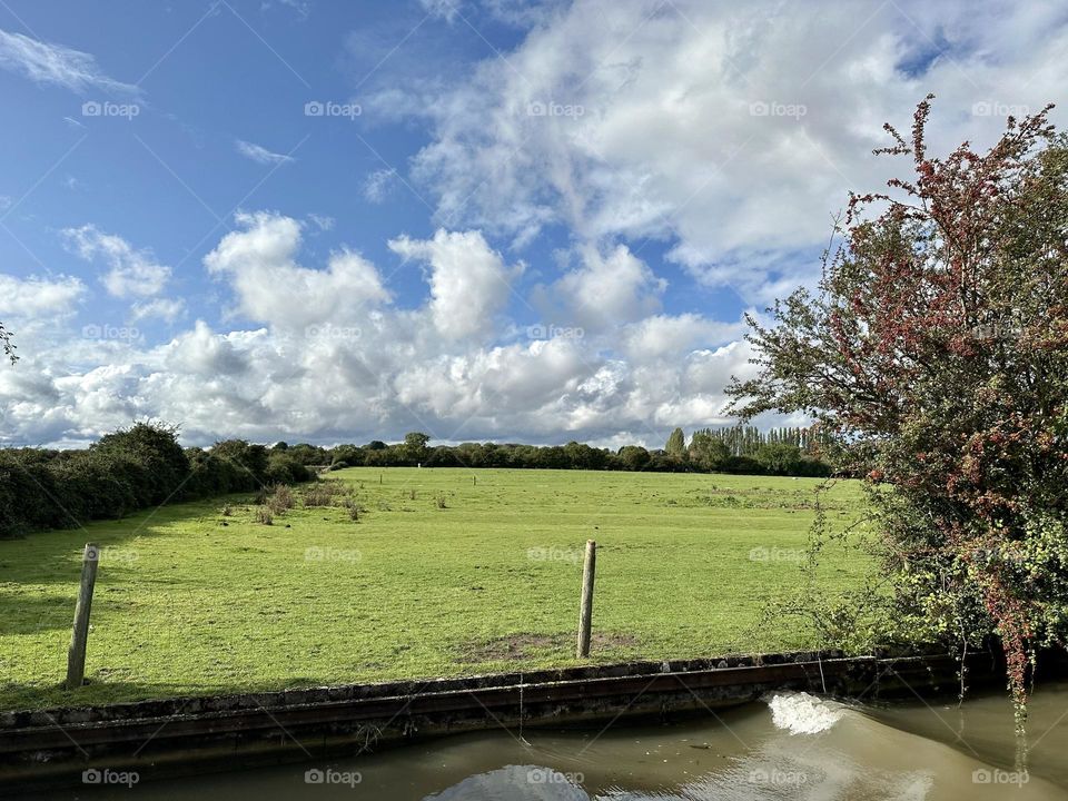 Afternoon narrowboat cruise up Oxford canal near Ansty en route to Hawkesbury junction beautiful sky cool clouds sunny late summer weather scenic horizon historic waterway England country vacation holiday