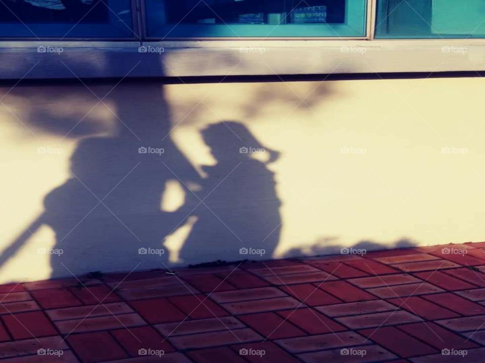 a shadow of a child i front of a mother.