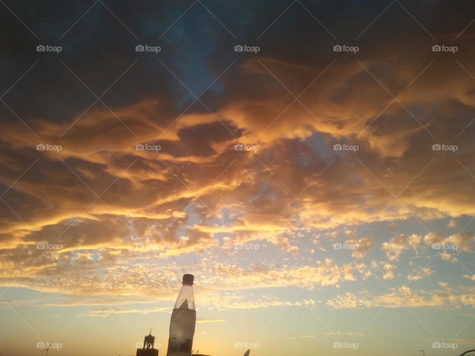 Scenic sky and a bottle embraces high sky.