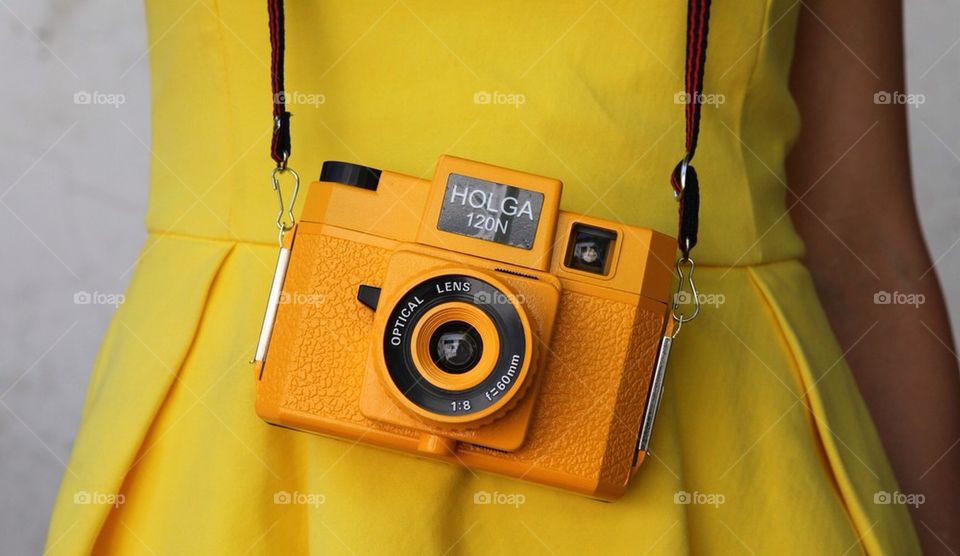 Vintage antique Holga 120mm film camera with leather strap, hanging