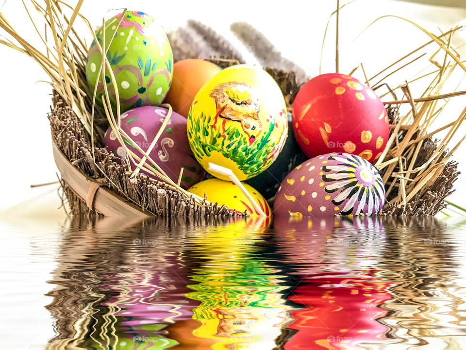 Colorful Easter egg with water reflection background 