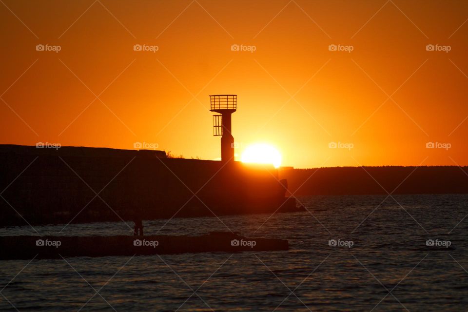 Sunrise at the seaside in Estonia with a strong orange colour.