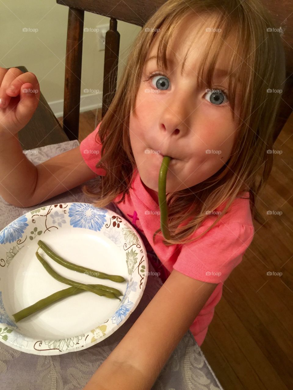 Girl carrying bean in the mouth