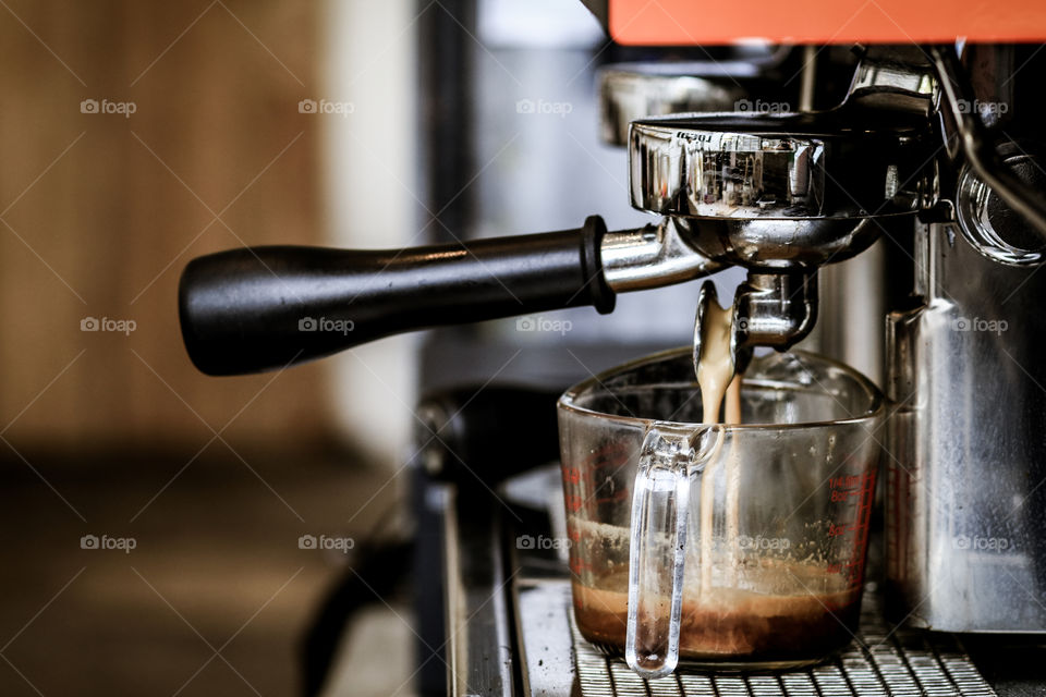 Espresso pouring from coffee machine 