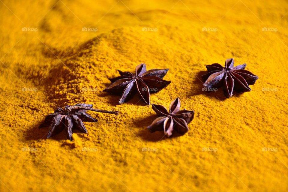 Star anise on turmeric powder