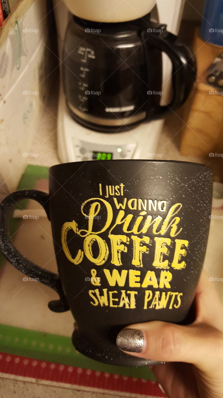 I love this coffee mug with the bright yellow lettering on the mug. Took the picture right before fixing myself a cup of coffee. That is my thumb with black & silver finger nail polish.