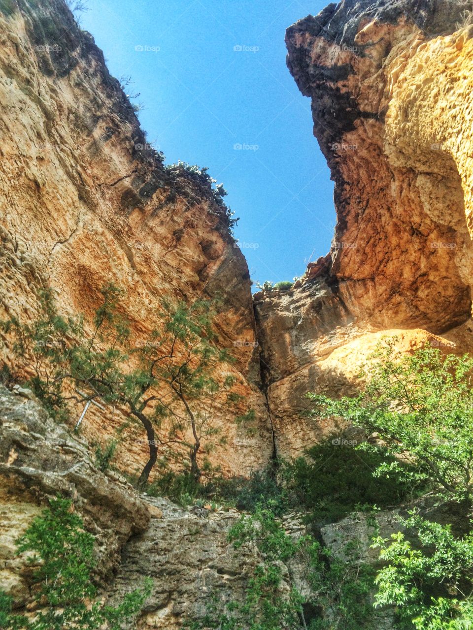 Looking up through the cliff to blue sky 