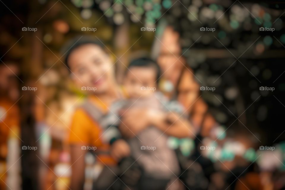 defocused abstract background of mom and son in a picnic