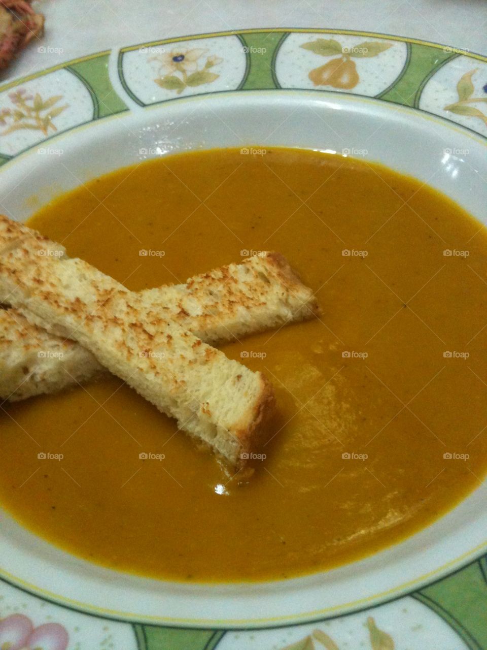 spicy pumpkin soup with toasted bread stick