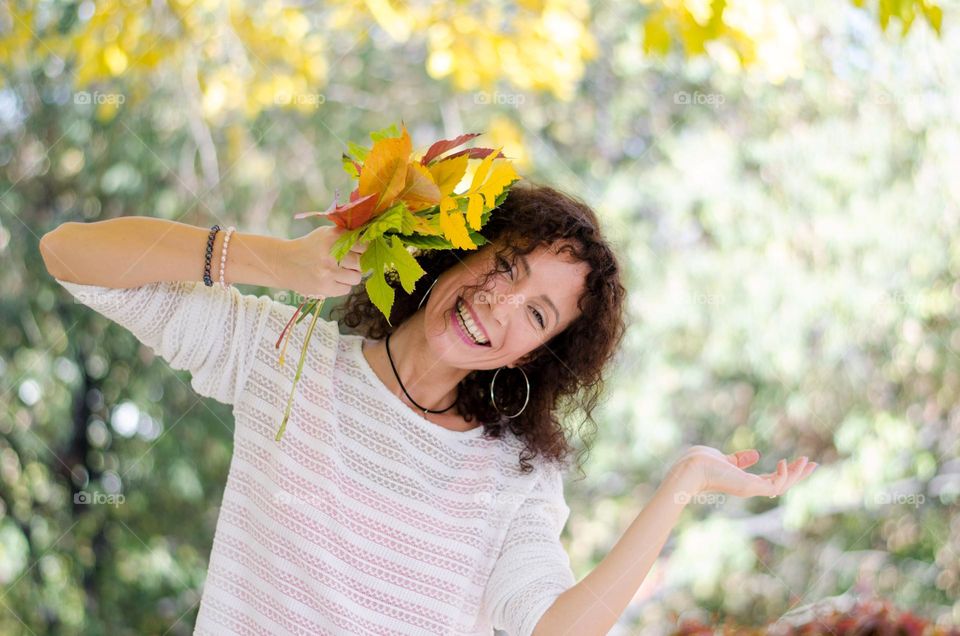 Smiling Young Girl on Autumn Background