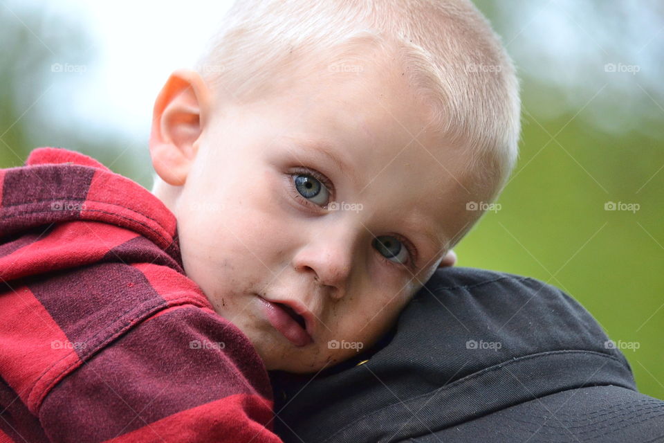 Toddler riding on his fathers shoulders