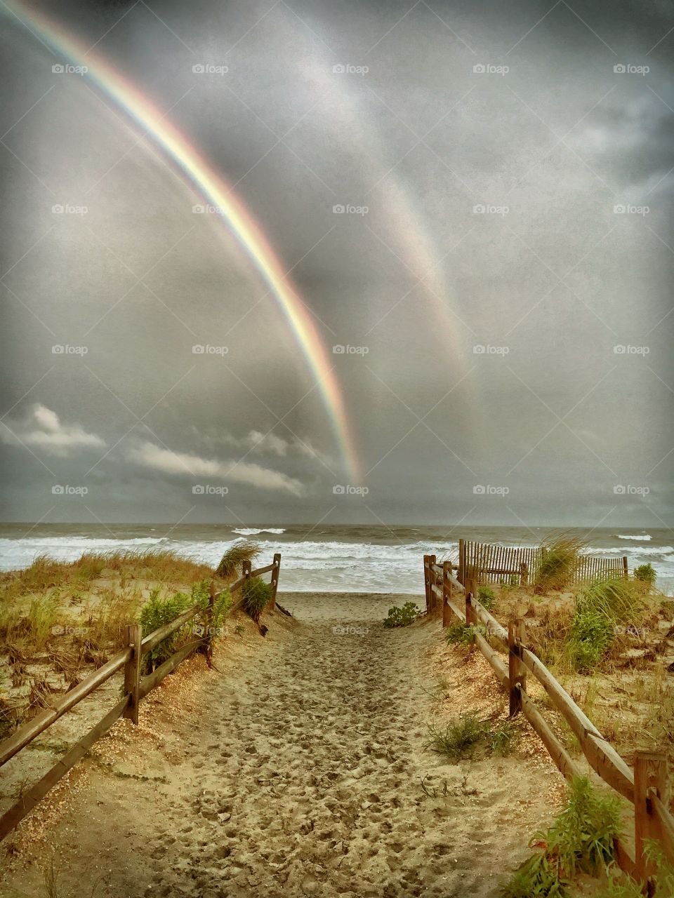 Double rainbow on a beach after a storm
