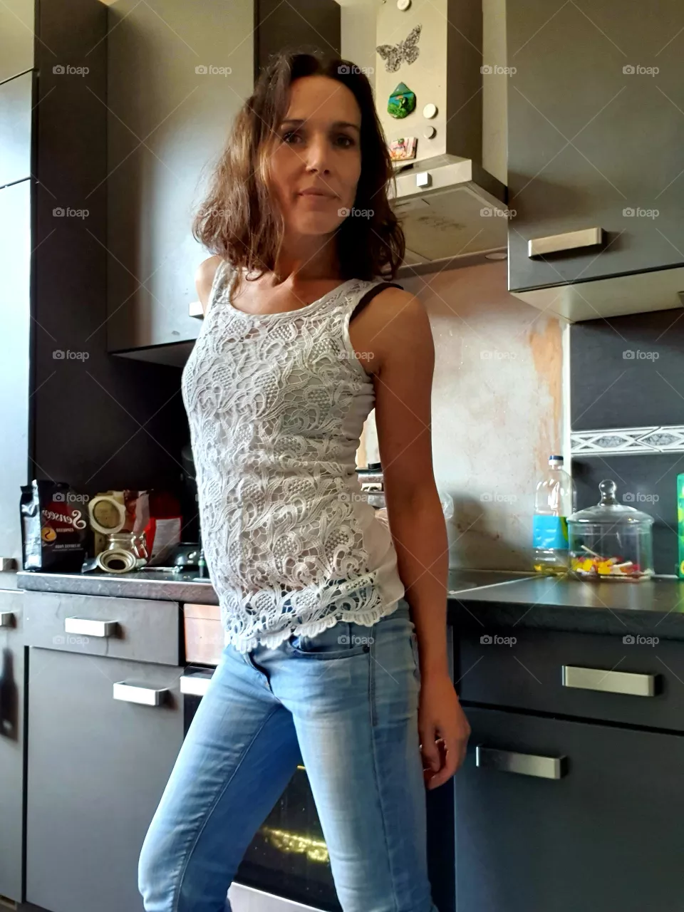 Woman in the kitchen looking at the camera.