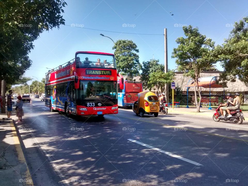 tourist bus in Cuba, beautiful red color, elegant, enjoying the place