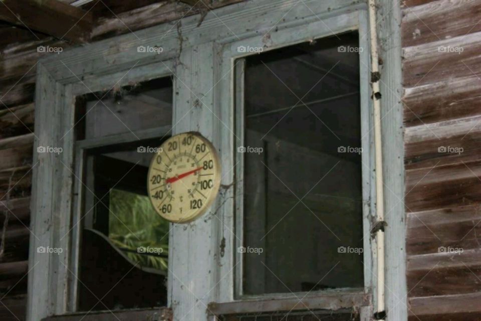 Windows. Temperature gauge on an old house.