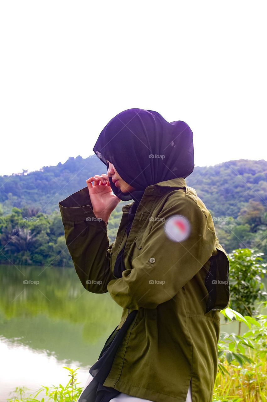 a girl daydreaming by the lake