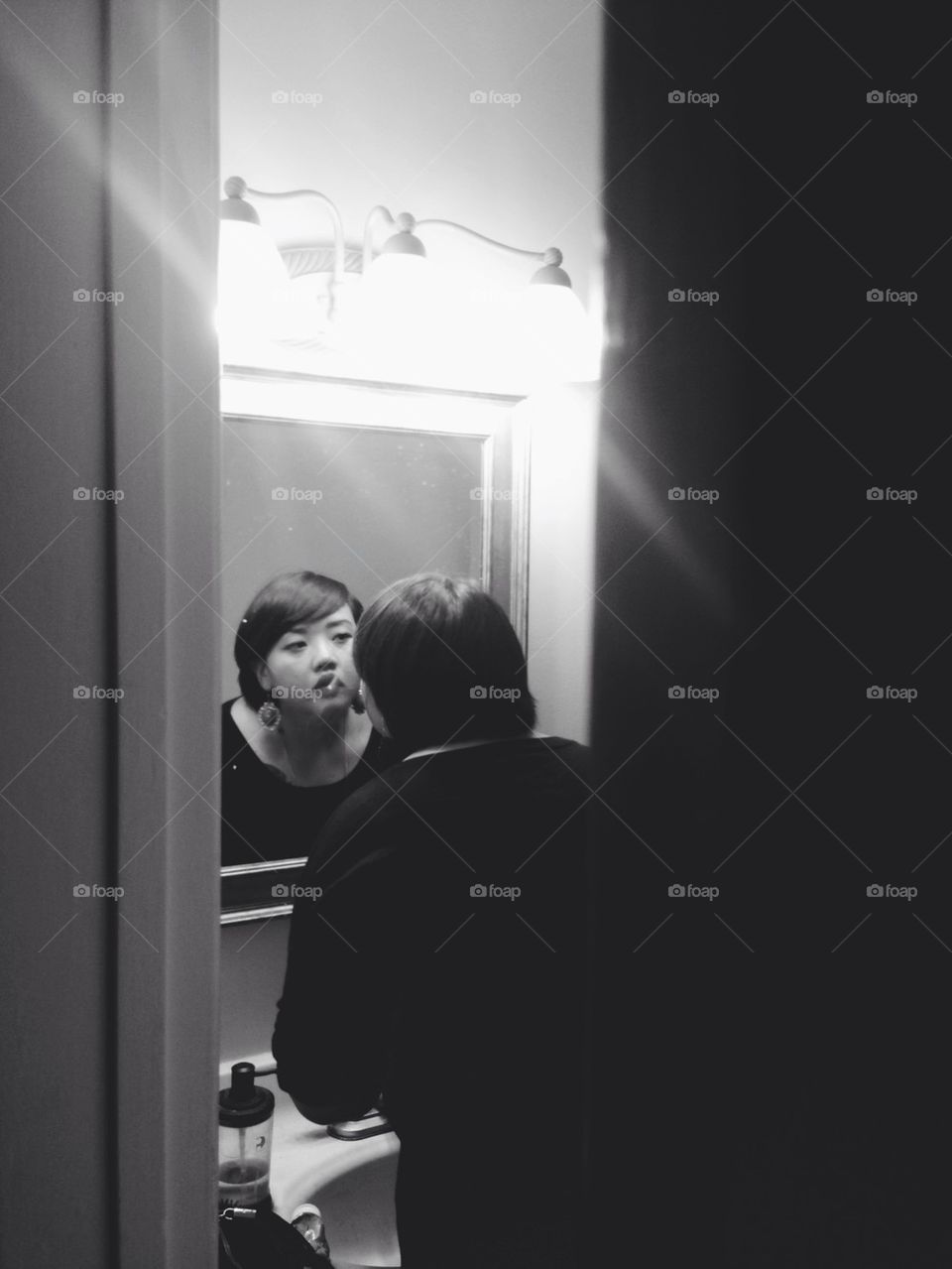 Woman looking in mirror