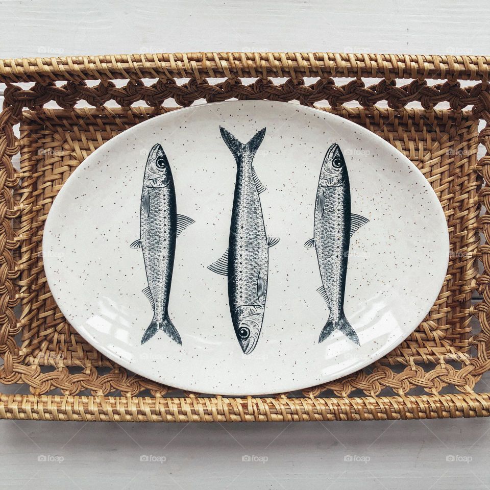 White oval dish with black-white image of fish by H&M