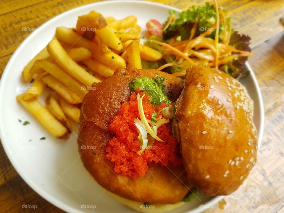 Fish burger with fries and salad