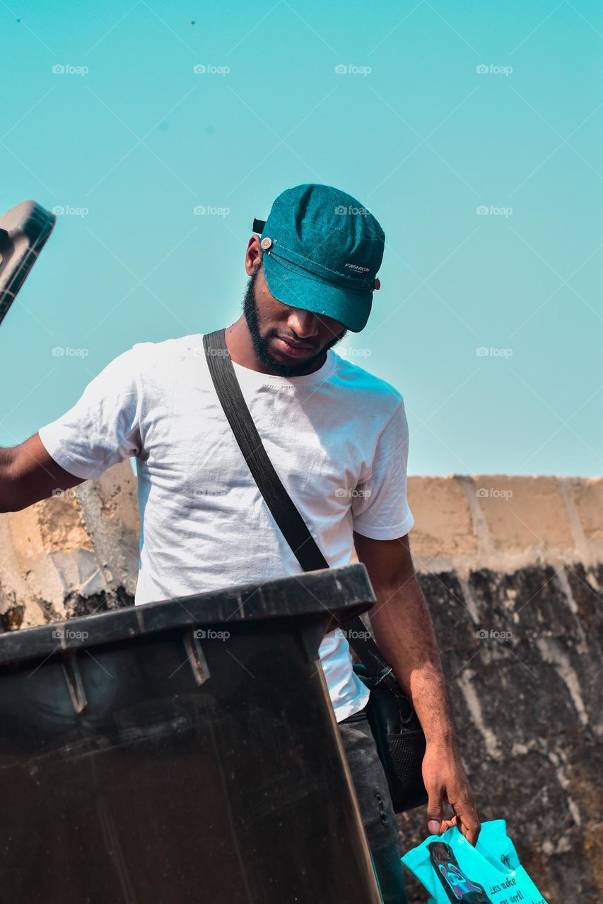 Throwing trash into the waste bin