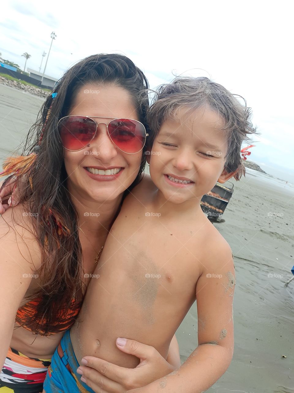 smiling woman and son on the beach in Santos