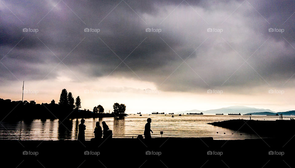 Silhouette of some people enjoying the beach