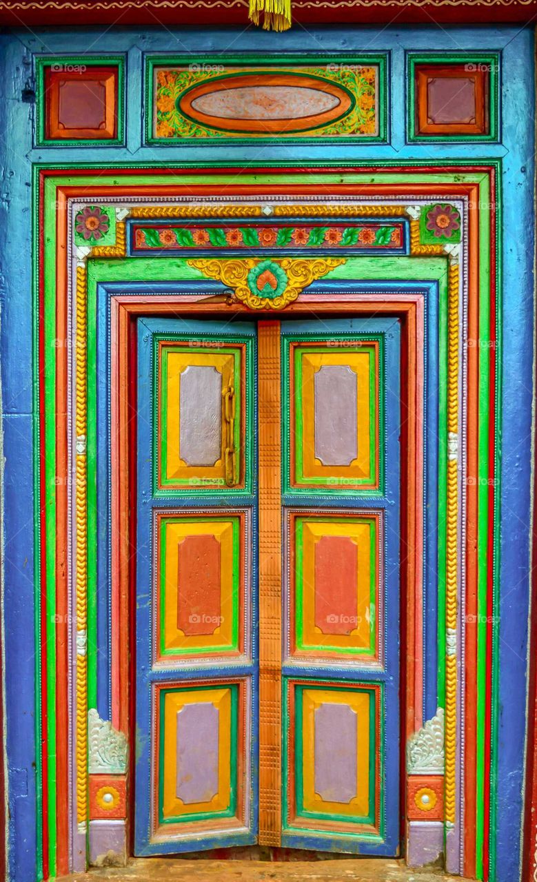 amazing ancient door very well maintained and multi colored. i would say royal door.