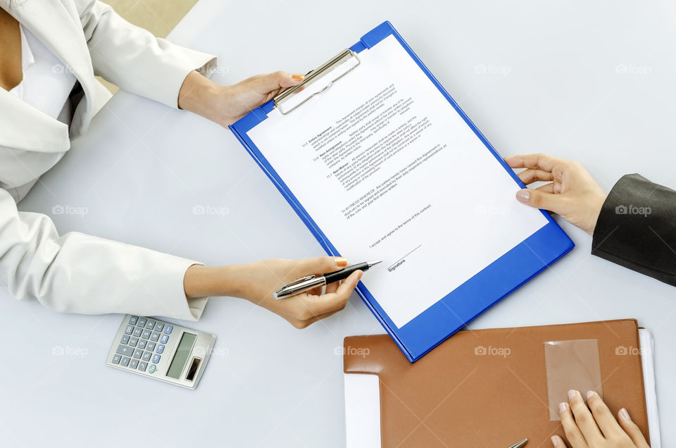 Two people signing business contract 