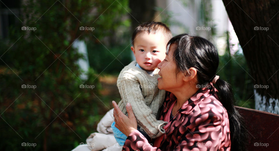 Mother carrying her son