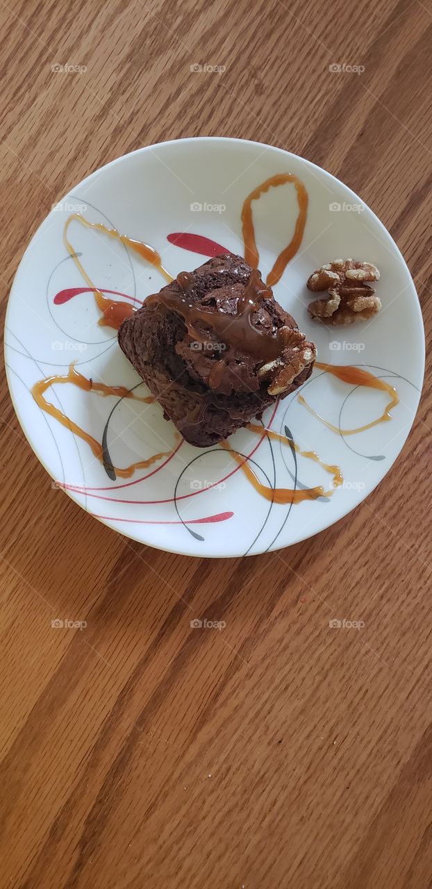 plated brownie with hot caramel and walnuts