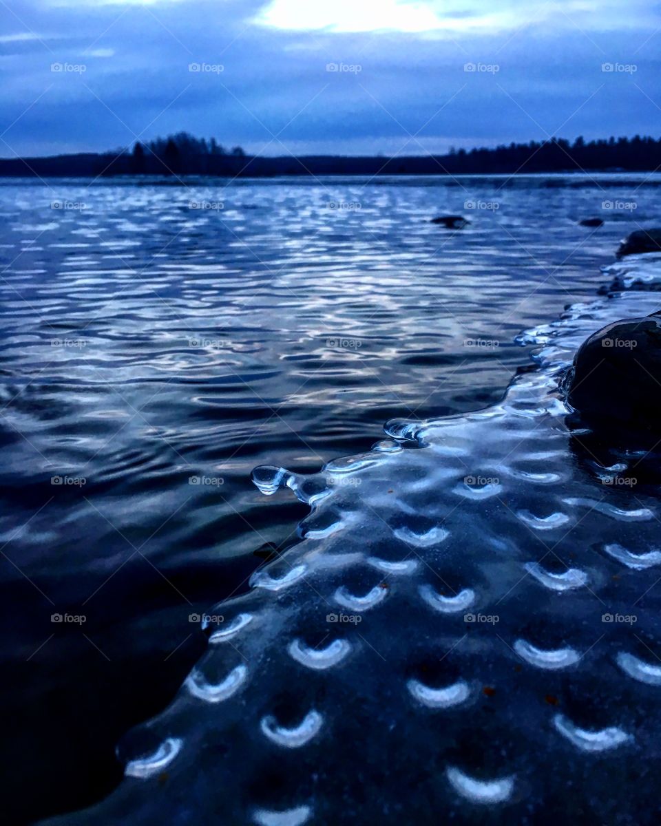 Circles forming under the ice on a frozen lake