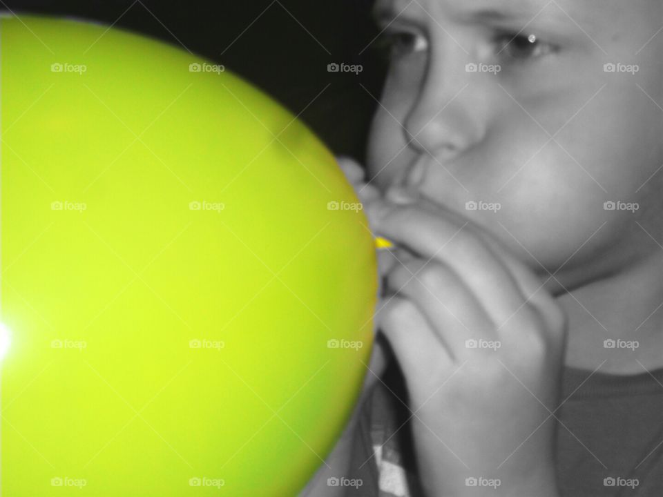 Blowing time!. Kid blowing a yellow balloon!