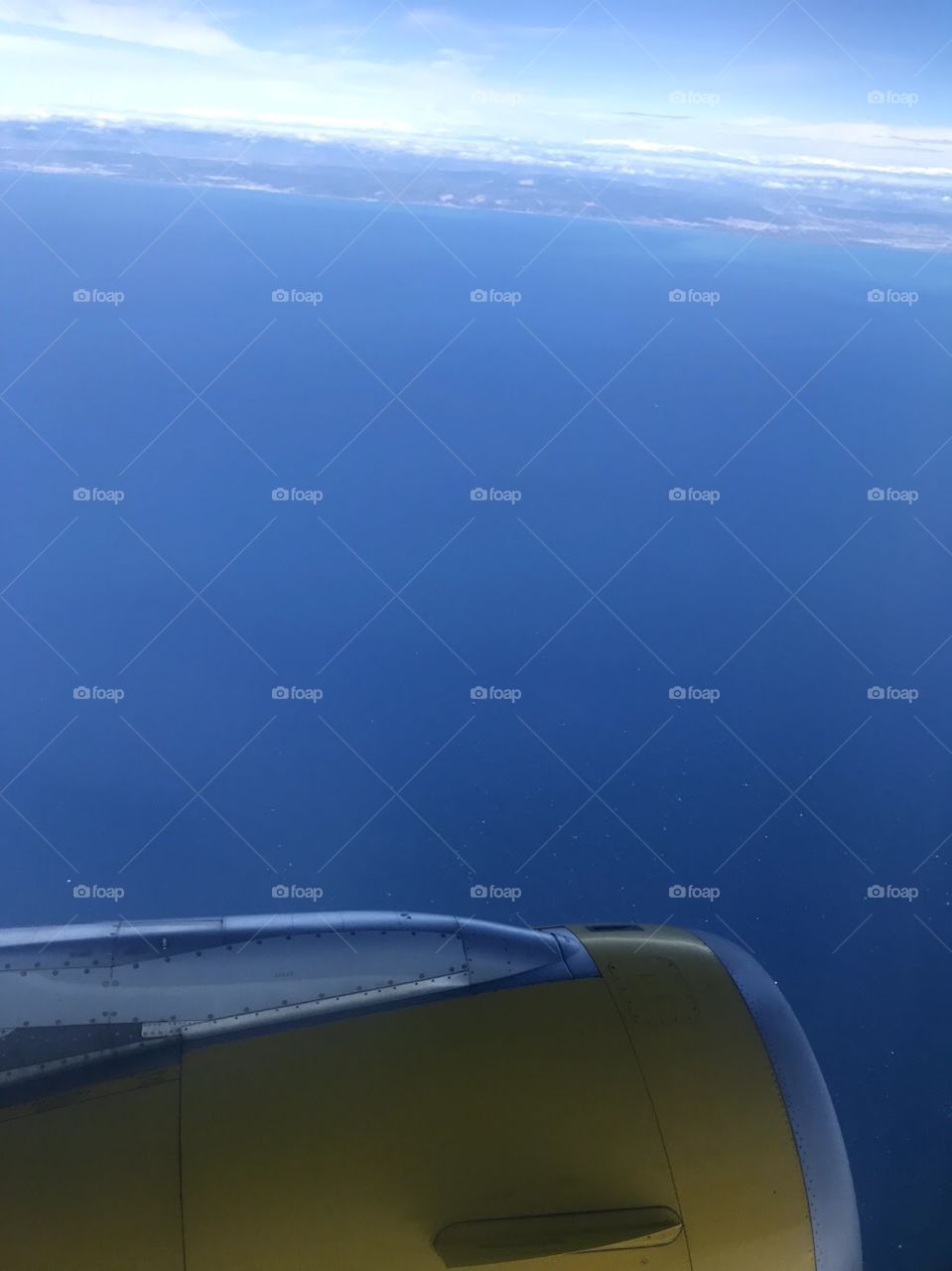 View from plane window of the ocean 