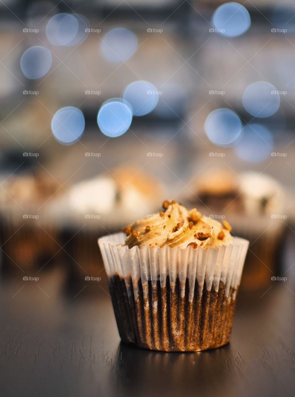 Closeup of a chocolate cupcake with caramel topping on the table