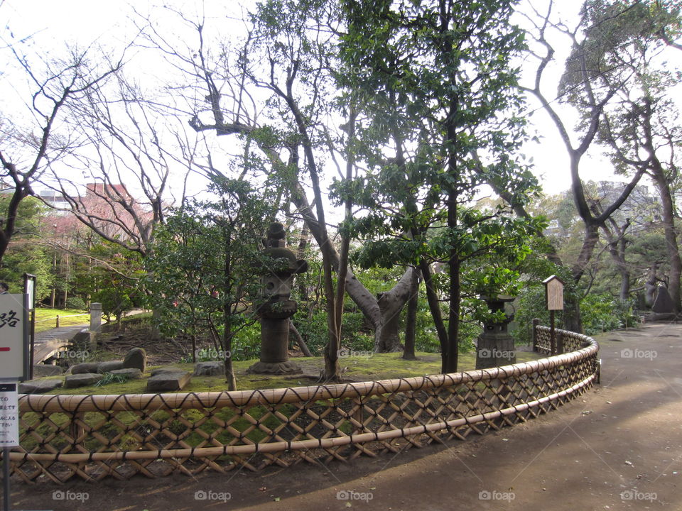 Asakusa Kannon. Sensoji Buddhist Temple and Gardens. Tokyo, Japan.  Trees, Stone Lantern and Memorial Plaques