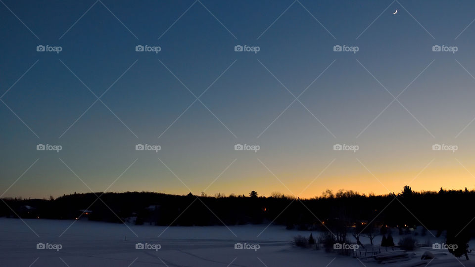 Peaceful nightfall during the winter, lake in Quebec, Canada