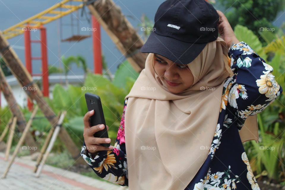 Woman in black hat taking selfie