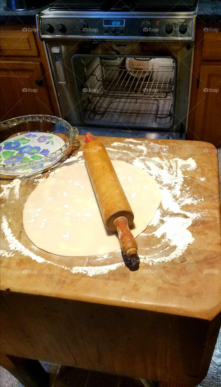 Rolling out crust for homemade pie.