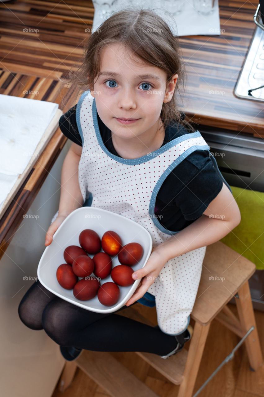 Little girl presenting her traditionally dyed Easter eggs. Easter tradition. Job done.