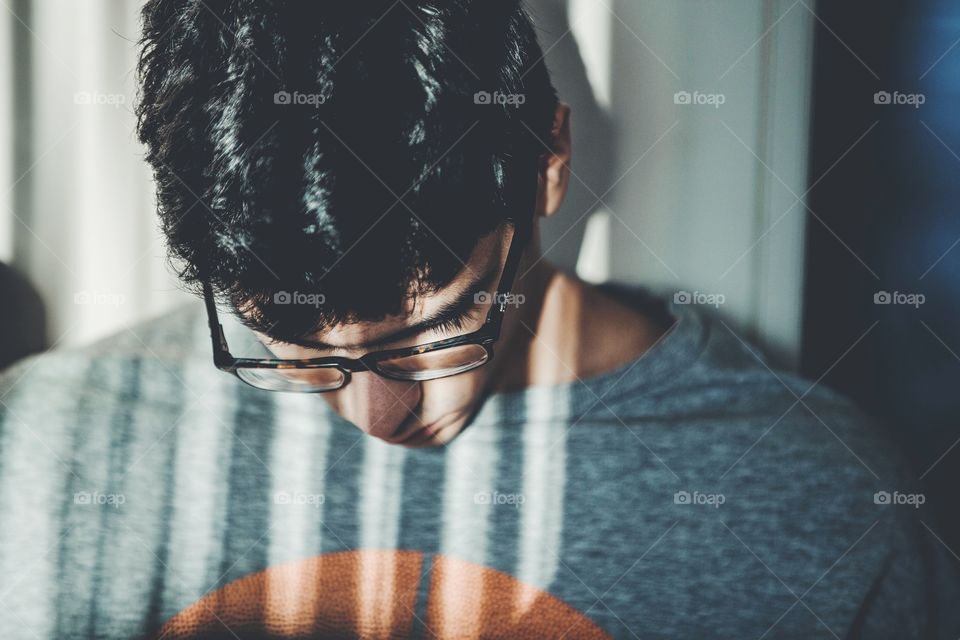 Young man in a light room with interestinf shadows