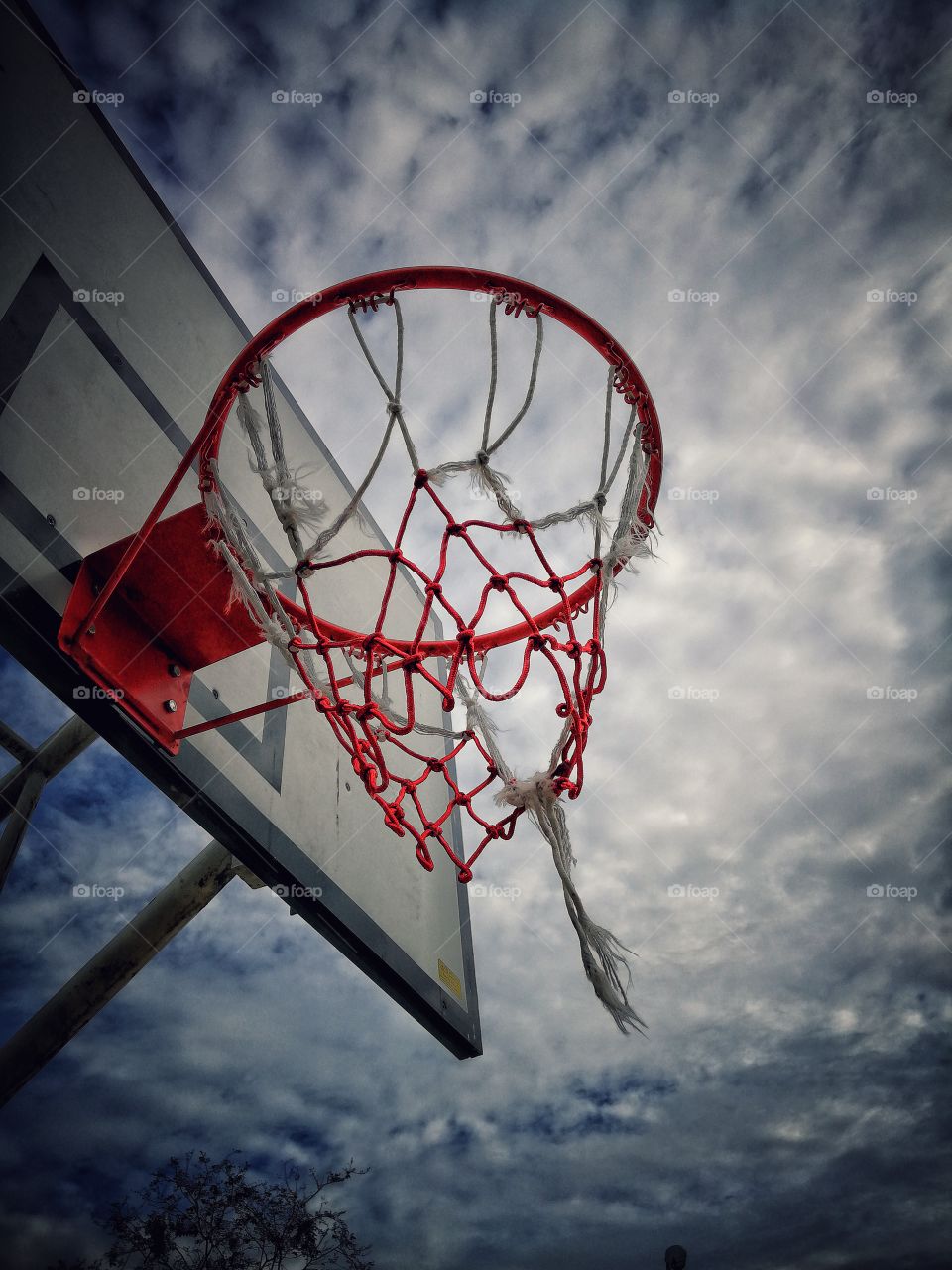 Basketball ball ring in the outdoor field overlooking the beautiful sky