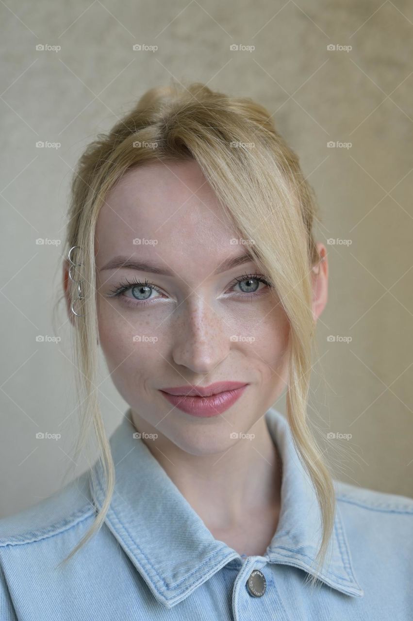 Portrait of a cute girl with blonde hair with a beautiful look