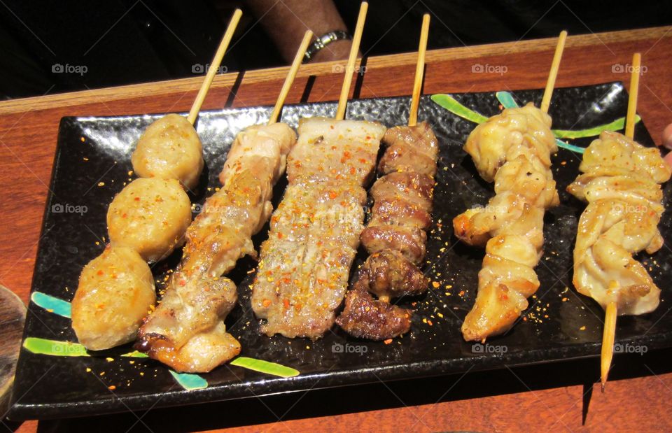 Japanese Yakitori.  Grilled and skewered chicken parts.  Pub food and snacks.