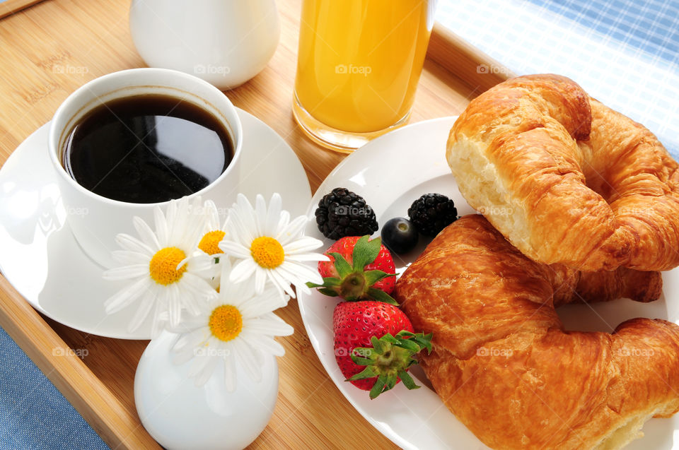 Breakfast with croissant, orange juice and coffee