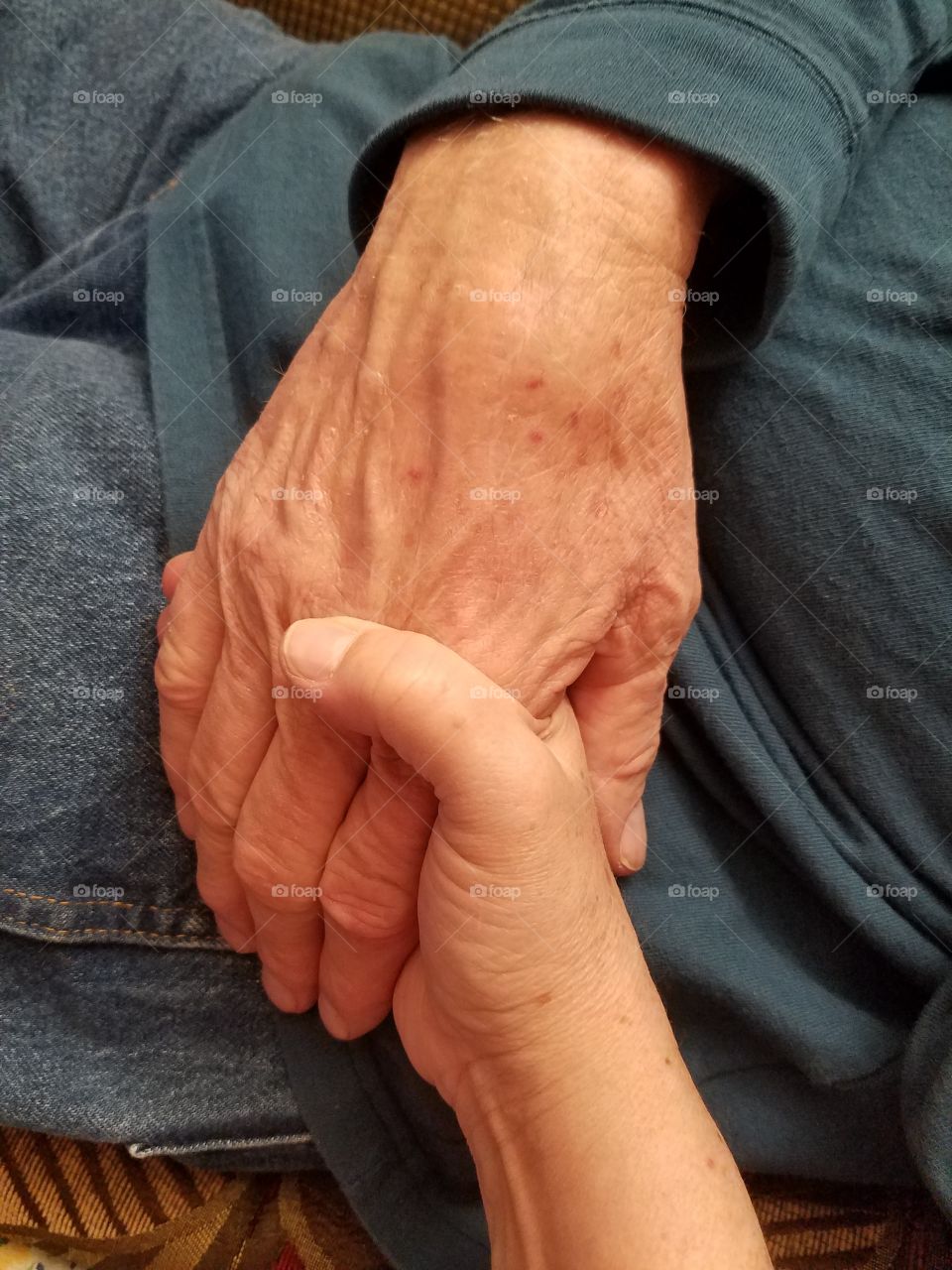 Person holding child's hands