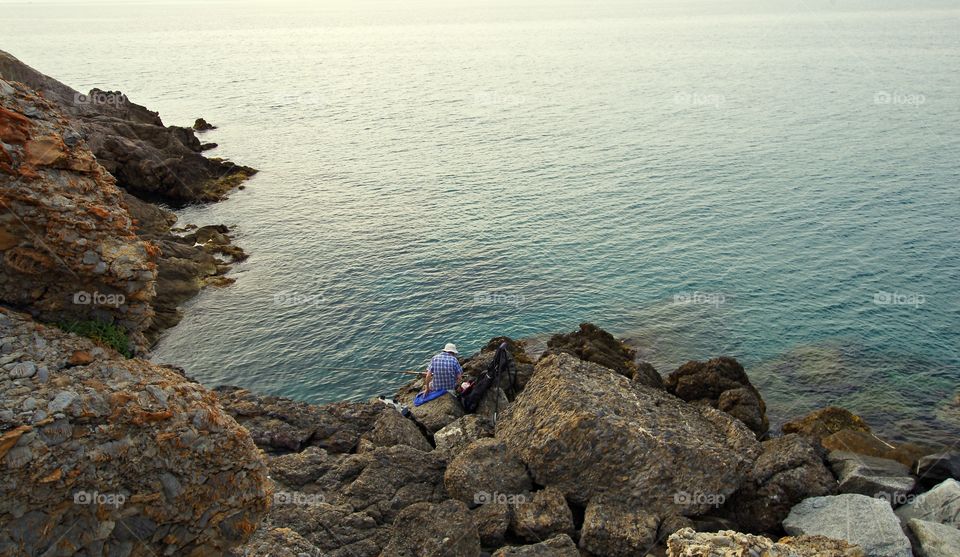 High angle view of man fishing in sea