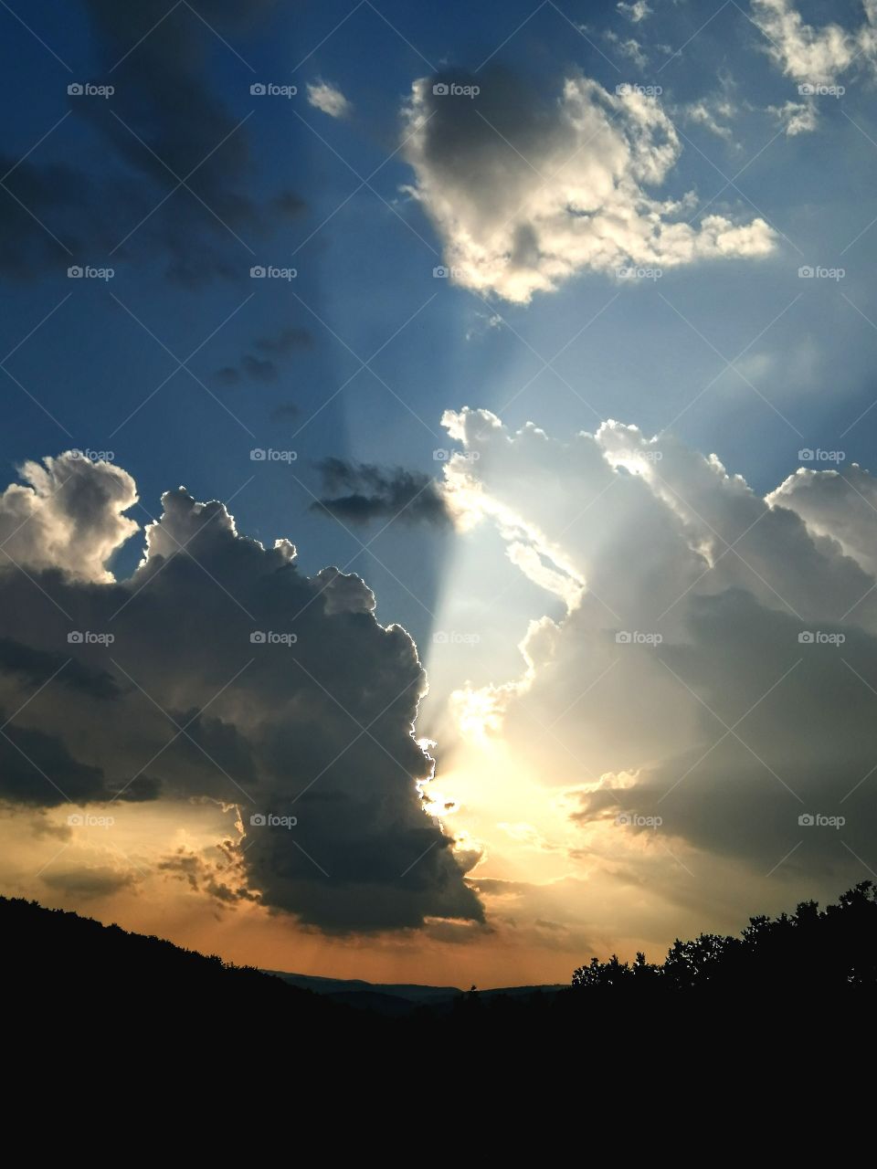 Sunset, clouds divided into light and dark side