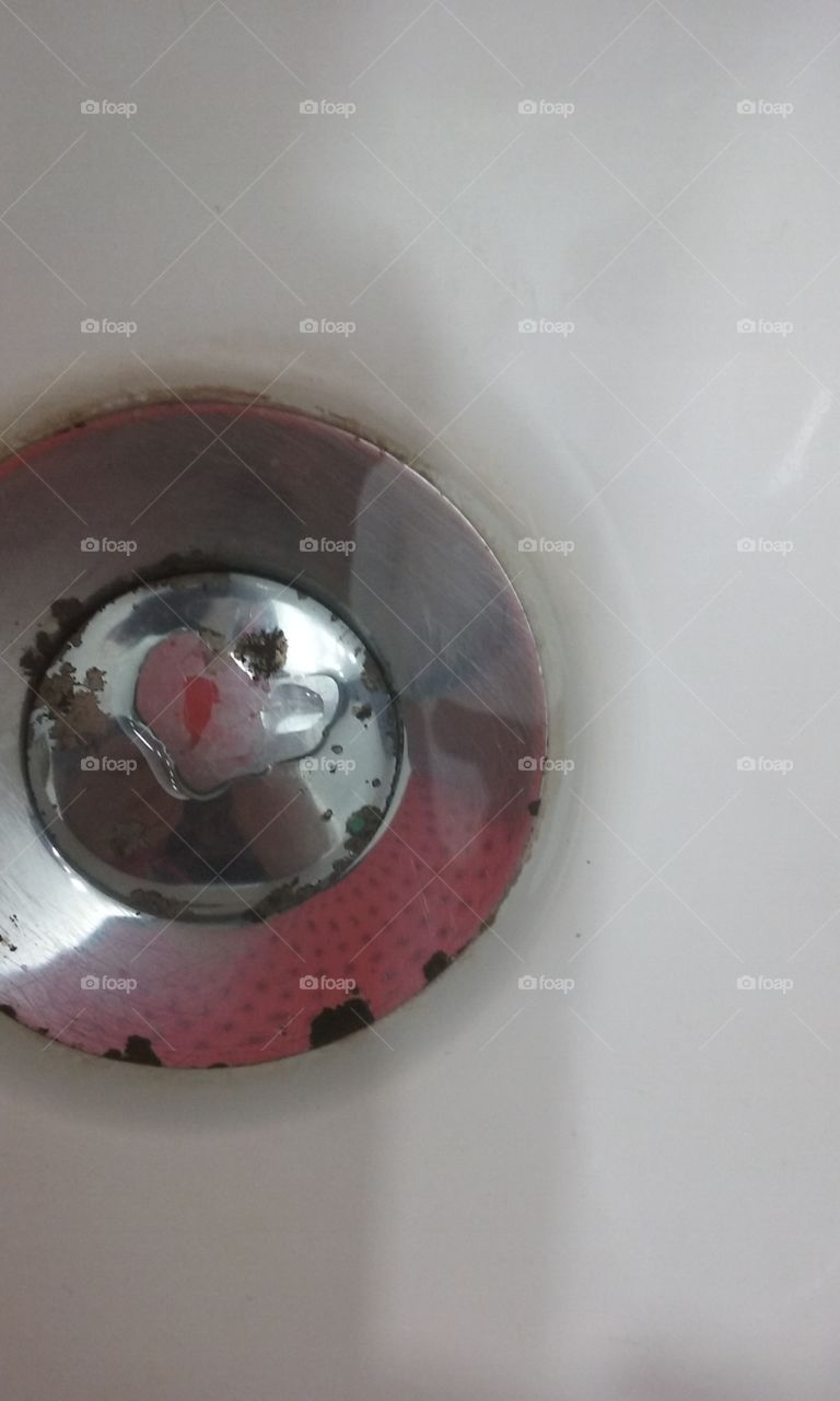 Heart shaped water drop on sink drain